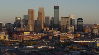 DX0001_002227 - 5.7K aerial stock footage of slowly flying by the city's downtown skyline at sunset in Downtown Minneapolis, Minnesota