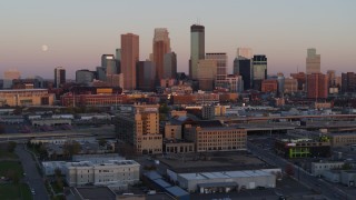 DX0001_002238 - 5.7K aerial stock footage of the city's skyline and moon at sunset, seen from marketplace, Downtown Minneapolis, Minnesota
