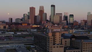 DX0001_002241 - 5.7K aerial stock footage passing city's skyline at sunset, seen from marketplace, Downtown Minneapolis, Minnesota