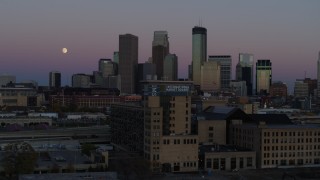 DX0001_002251 - 5.7K aerial stock footage flying by the city's downtown skyline at twilight, reveal moon and market, Downtown Minneapolis, Minnesota