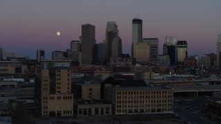 DX0001_002252 - 5.7K aerial stock footage passing by the city's downtown skyline at twilight, reveal moon and market, Downtown Minneapolis, Minnesota