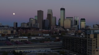 DX0001_002257 - 5.7K aerial stock footage of the moon near the city's downtown skyline at twilight, reveal market, Downtown Minneapolis, Minnesota