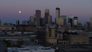 DX0001_002258 - 5.7K aerial stock footage flyby market with the moon near the city's downtown skyline at twilight, Downtown Minneapolis, Minnesota