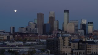 DX0001_002264 - 5.7K aerial stock footage passing market with the city's skyline and moon in background at twilight, Downtown Minneapolis, Minnesota