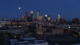 DX0001_002275 - 5.7K aerial stock footage flyby market building with the moon above city skyline at twilight, Downtown Minneapolis, Minnesota
