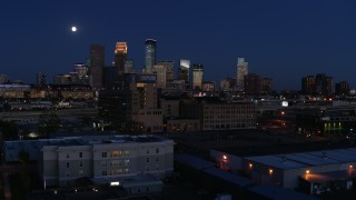 DX0001_002283 - 5.7K aerial stock footage approach market building with moon above city's skyline at twilight, Downtown Minneapolis, Minnesota