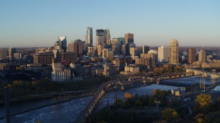 DX0001_002291 - 5.7K aerial stock footage flyby bridge with the city skyline across the river at sunrise, Downtown Minneapolis, Minnesota