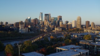 DX0001_002294 - 5.7K aerial stock footage of the city skyline across the Mississippi River at sunrise, Downtown Minneapolis, Minnesota