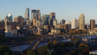 DX0001_002303 - 5.7K aerial stock footage of a view of skyline across the Mississippi River at sunrise, Downtown Minneapolis, Minnesota