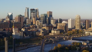 DX0001_002304 - 5.7K aerial stock footage of a view of the city skyline across the Mississippi River at sunrise, Downtown Minneapolis, Minnesota