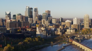 DX0001_002306 - 5.7K aerial stock footage flyby power plant for view of city skyline across the river at sunrise, Downtown Minneapolis, Minnesota