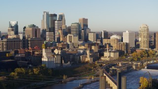 DX0001_002308 - 5.7K aerial stock footage passing by the city skyline seen from the river at sunrise, Downtown Minneapolis, Minnesota