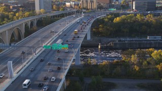 DX0001_002315 - 5.7K aerial stock footage of slow traffic crossing a bridge at sunrise, Minneapolis, Minnesota