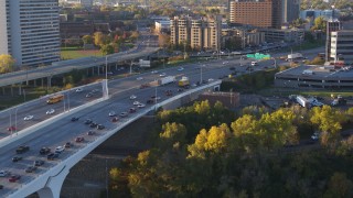DX0001_002316 - 5.7K aerial stock footage of slow traffic backing up on a bridge at sunrise, Minneapolis, Minnesota