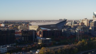 DX0001_002317 - 5.7K aerial stock footage of US Bank Stadium at sunrise, Downtown Minneapolis, Minnesota