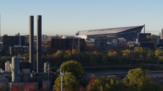 DX0001_002318 - 5.7K aerial stock footage of US Bank Stadium at sunrise, seen from power plant, Downtown Minneapolis, Minnesota