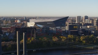 DX0001_002319 - 5.7K aerial stock footage of US Bank Stadium on the other side of the river at sunrise, Downtown Minneapolis, Minnesota