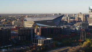DX0001_002320 - 5.7K aerial stock footage of US Bank Stadium on the other side of the river at sunrise, Downtown Minneapolis, Minnesota