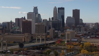 DX0001_002380 - 5.7K aerial stock footage ascend near bridge and towering skyscrapers of the city skyline, Downtown Minneapolis, Minnesota