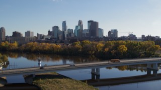 DX0001_002463 - 5.7K aerial stock footage flyby bridge over the river with a view of the skyline of Downtown Minneapolis, Minnesota