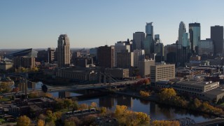 DX0001_002492 - 5.7K aerial stock footage of approaching bridge spanning the river and the city skyline, Downtown Minneapolis, Minnesota