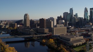DX0001_002493 - 5.7K aerial stock footage of residential skyscraper near bridge spanning the river, Downtown Minneapolis, Minnesota
