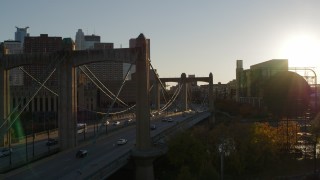 DX0001_002502 - 5.7K aerial stock footage ascend from Hennepin Avenue Bridge at sunset in Downtown Minneapolis, Minnesota
