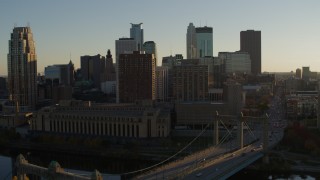 DX0001_002503 - 5.7K aerial stock footage fly away from Hennepin Avenue Bridge and apartment buildings at sunset in Downtown Minneapolis, Minnesota