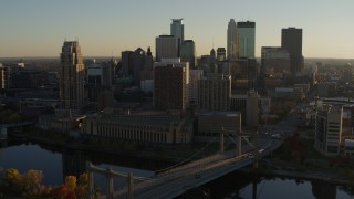 DX0001_002504 - 5.7K aerial stock footage fly by Hennepin Avenue Bridge and apartment buildings at sunset in Downtown Minneapolis, Minnesota