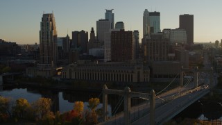 DX0001_002505 - 5.7K aerial stock footage descend by Hennepin Avenue Bridge and apartment buildings at sunset in Downtown Minneapolis, Minnesota