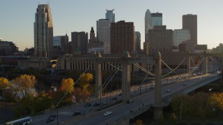 DX0001_002506 - 5.7K aerial stock footage approach light traffic on Hennepin Avenue Bridge at sunset in Downtown Minneapolis, Minnesota