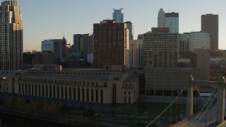 DX0001_002507 - 5.7K aerial stock footage flyby Hennepin Avenue Bridge, post office and apartment buildings at sunset, Downtown Minneapolis, Minnesota