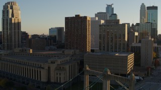 DX0001_002508 - 5.7K aerial stock footage of post office and apartment buildings at sunset near bridge, Downtown Minneapolis, Minnesota