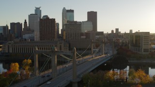 DX0001_002510 - 5.7K aerial stock footage flyby Hennepin Avenue Bridge at sunset, with view of Downtown Minneapolis, Minnesota