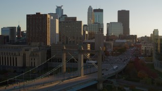 DX0001_002511 - 5.7K aerial stock footage flyby and approach Hennepin Avenue Bridge at sunset near apartment buildings, Downtown Minneapolis, Minnesota
