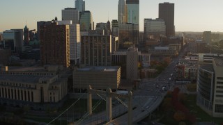 DX0001_002512 - 5.7K aerial stock footage ascend near Hennepin Avenue Bridge at sunset near apartment and USPS buildings, Downtown Minneapolis, Minnesota