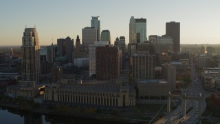 DX0001_002513 - 5.7K aerial stock footage flyby skyscrapers and descend by Hennepin Avenue Bridge at sunset, Downtown Minneapolis, Minnesota