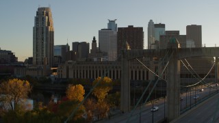DX0001_002518 - 5.7K aerial stock footage descend by USPS and apartment buildings at sunset, reveal bridge in Downtown Minneapolis, Minnesota