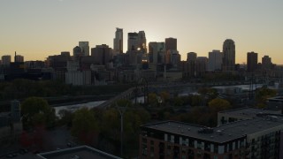 DX0001_002524 - 5.7K aerial stock footage of flying by the city skyline across river at sunset, reveal power plant, Downtown Minneapolis, Minnesota