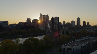 DX0001_002530 - 5.7K aerial stock footage of city skyline while flying over power plant and river at sunset, Downtown Minneapolis, Minnesota