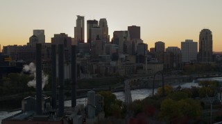DX0001_002533 - 5.7K aerial stock footage of city skyline across the Mississippi River at sunset, seen from power plant, Downtown Minneapolis, Minnesota