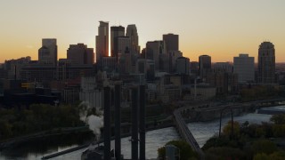 DX0001_002535 - 5.7K aerial stock footage of city skyline across the Mississippi River at sunset, seen from the power plant, Downtown Minneapolis, Minnesota