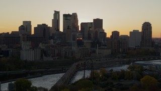 DX0001_002536 - 5.7K aerial stock footage of city skyline across the Mississippi River at sunset, and reveal the power plant, Downtown Minneapolis, Minnesota