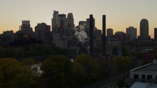 DX0001_002537 - 5.7K aerial stock footage flyby the power plant with city skyline in background at sunset, Downtown Minneapolis, Minnesota