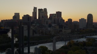 DX0001_002539 - 5.7K aerial stock footage flyby river with view of city skyline in background at sunset, reveal power plant, Downtown Minneapolis, Minnesota