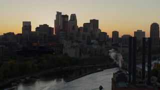 DX0001_002541 - 5.7K aerial stock footage flyby river with view of city skyline at sunset, reveal the power plant, Downtown Minneapolis, Minnesota