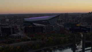 DX0001_002545 - 5.7K aerial stock footage of passing by US Bank Stadium at sunset, Downtown Minneapolis, Minnesota