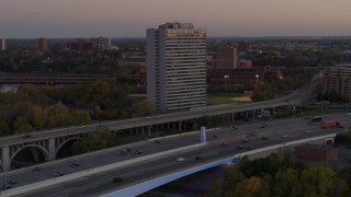 DX0001_002548 - 5.7K aerial stock footage of a condo complex seen from a bridge at sunset, Minneapolis, Minnesota