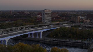 DX0001_002550 - 5.7K aerial stock footage fly away from a condo complex beside a bridge at sunset, Minneapolis, Minnesota