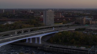 DX0001_002551 - 5.7K aerial stock footage slow approach to a condo complex beside a bridge at sunset, Minneapolis, Minnesota